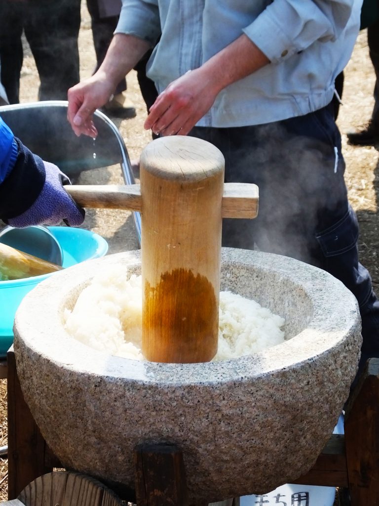 steamed rice in a stone mortar