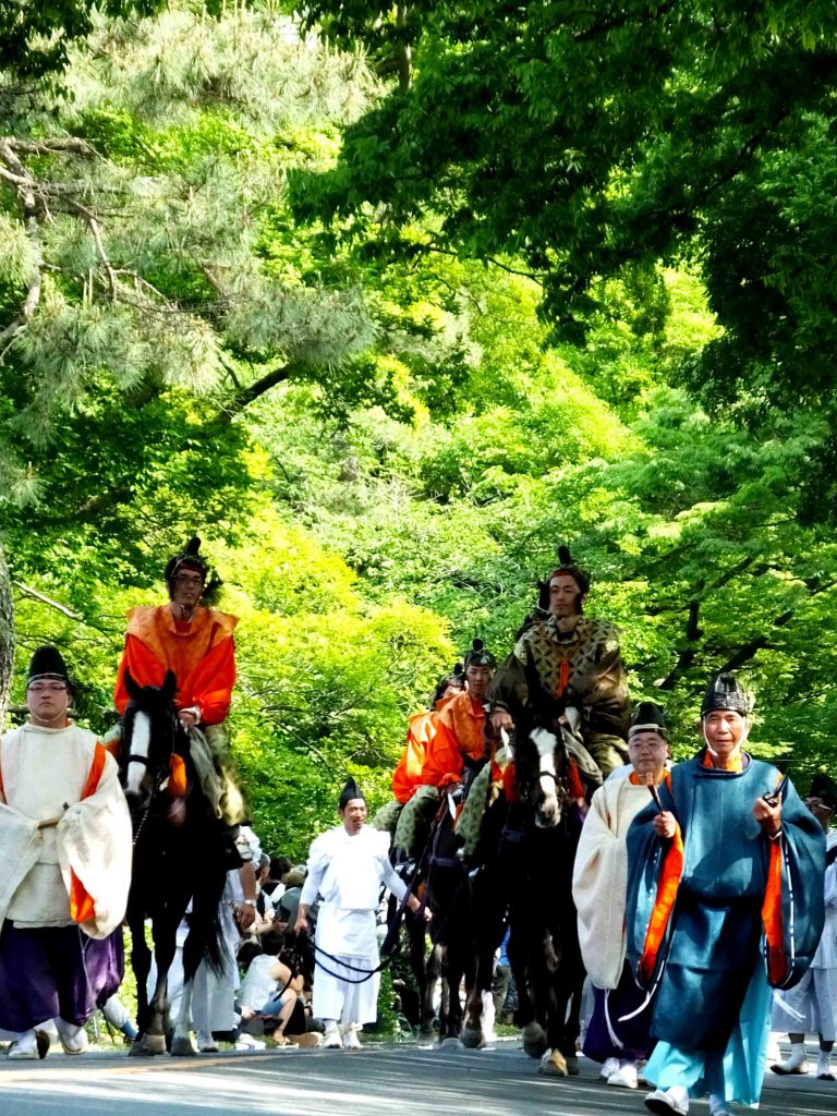 the procession under the fresh green trrees