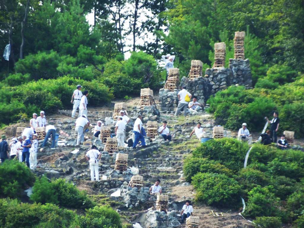 men preparing for the bonfires on Mt. Hidari Daimonji